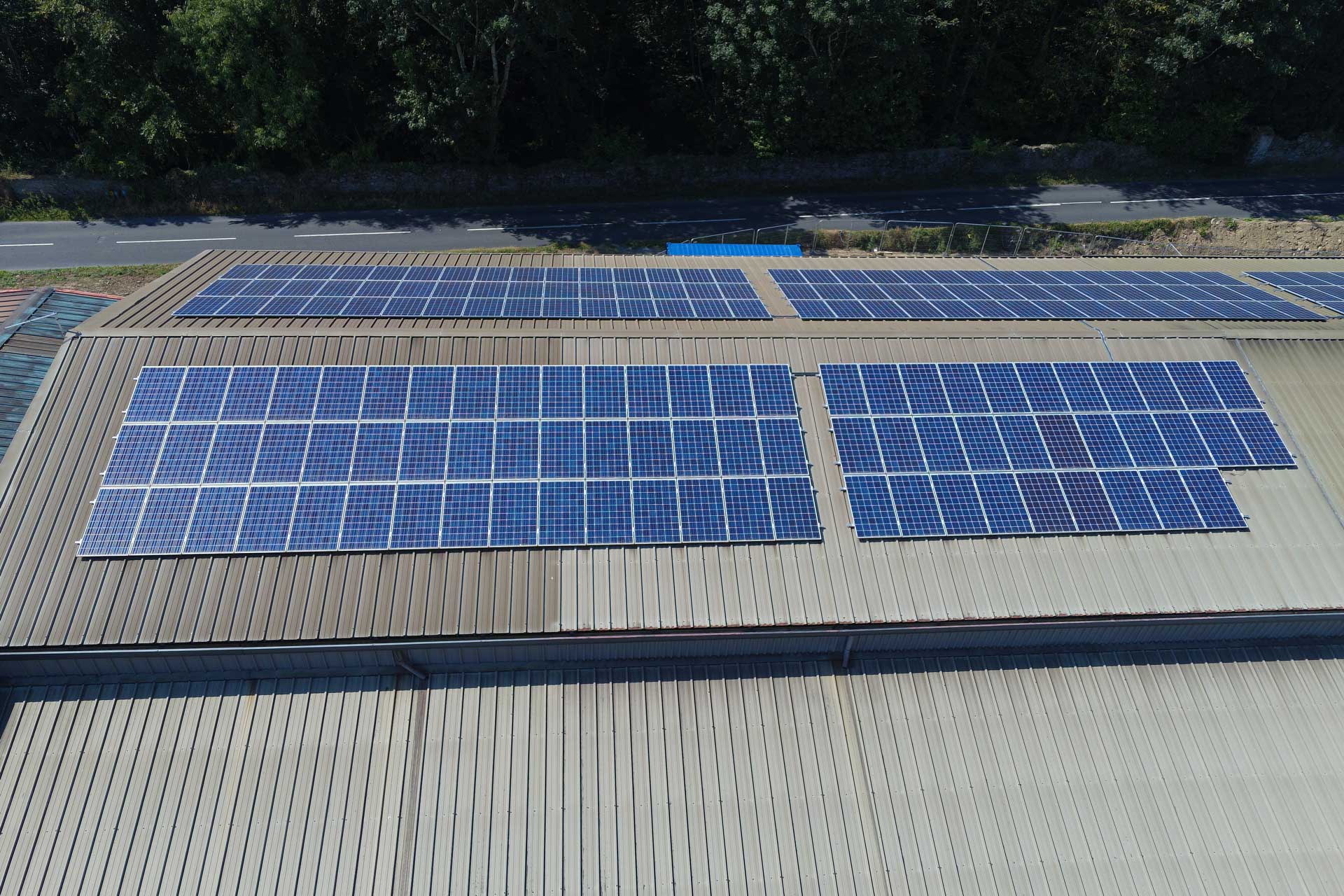 Panel rows above the Deli Lites production floor, sized for daytime refrigeration load