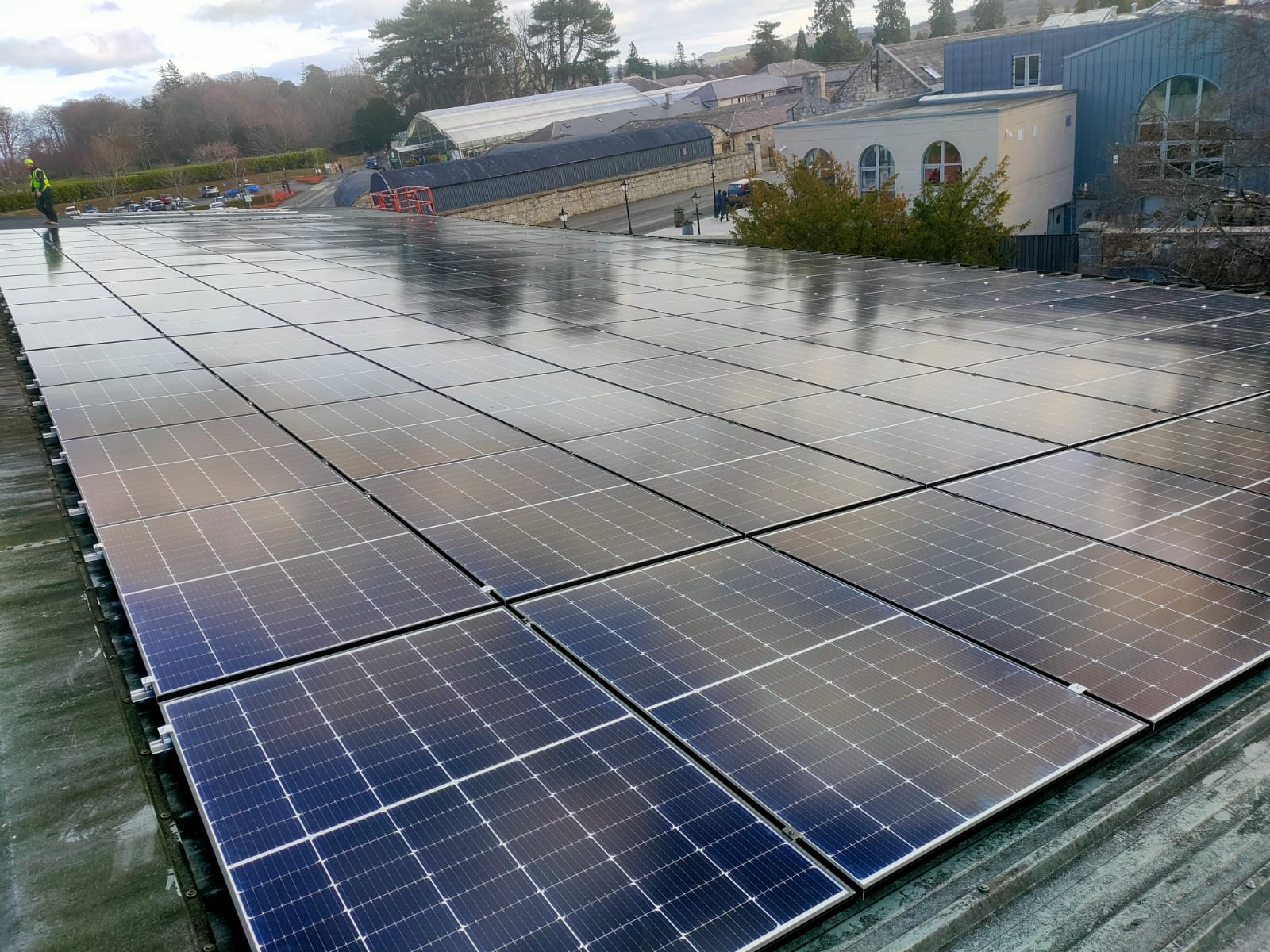 High-angle view of commercial solar panels on the Powerscourt Distillery rooftop